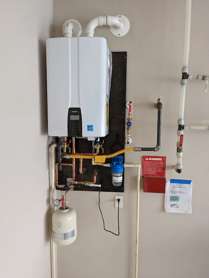 Professional plumber installing copper piping in a Port Hueneme home